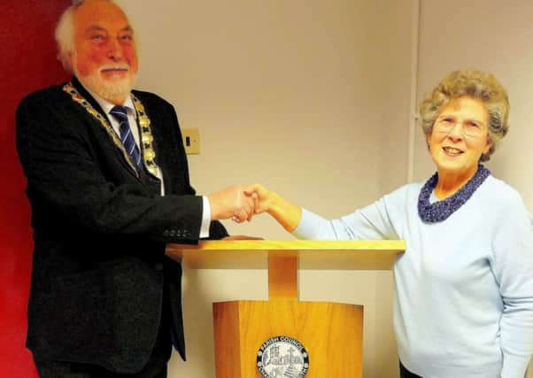 Mike Evanson, Chairman of Chapel-en-le-Frith Parish Council, accepting the gift of a new lectern for Chapel-en-le-Frith Town Hall from Mrs Beryl Martin.