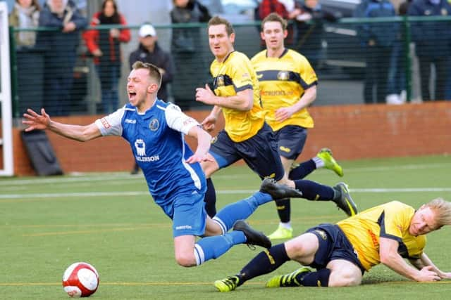 Buxton v Gainsborough Trinity. 
Brad Grayson's first half charge is halted by Simon Russell.