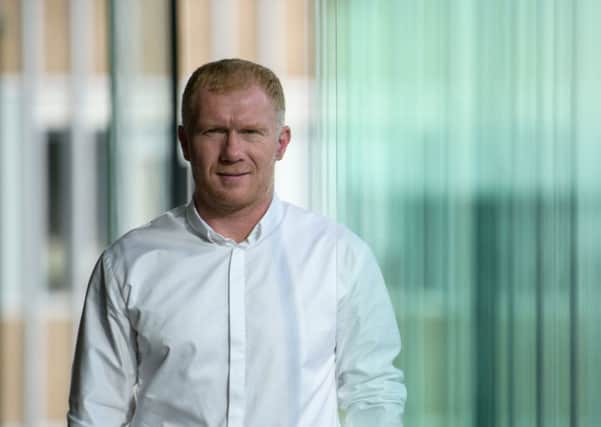 New Oldham boss Paul Scholes knows he has the very best help at hand. (Photo by Anthony WALLACE / AFP)