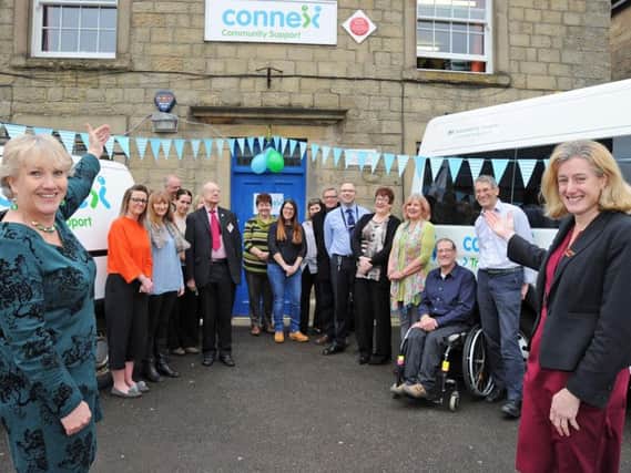 Gill Geddes, left, the chief executive of Connex Community Support and MP Ruth George, right, pictured with staff and invited guests at the launch of the re-named community charity on Buxton Market Place on Friday. Photo: Anne Shelley.
