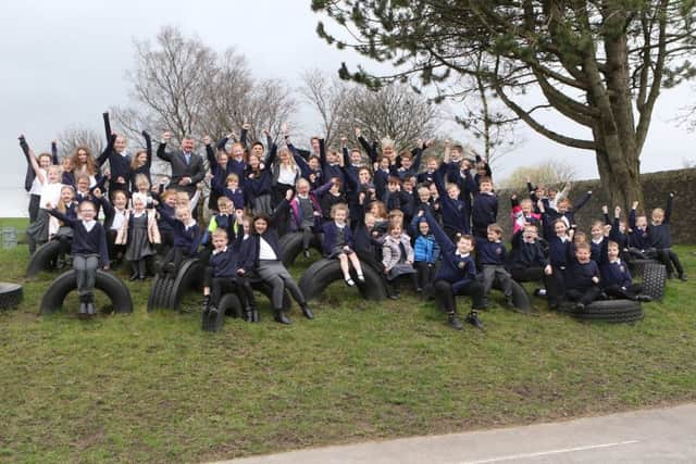 Staff and pupils at Peak Dale Primary School celebrate their latest Ofsted report.