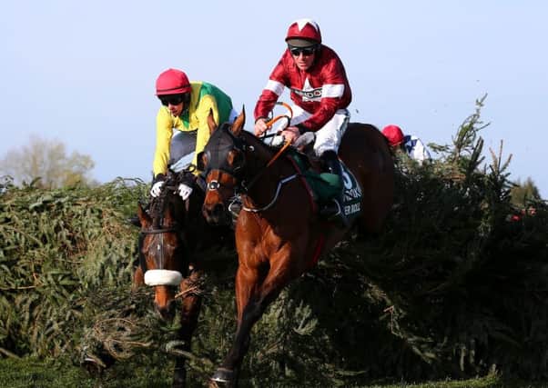Tiger Rolls jumps to the front at the final fence, where runner-up Magic Of Light makes a mistake. (PHOTO BY: Alex Livesey/Getty Images).