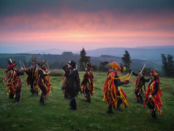 Dancers celebrate as dawn breaks in Derbyshire on May Day.
