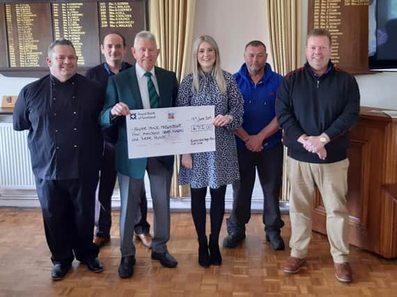 Becca Gregory receives a cheque from Chris Palmer, club president, and
other representatives from Buxton and High Peak Golf Club.