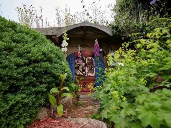 Chris Heild created a sunken hobbit hole - complete with circular door - using reclaimed bricks and timber.