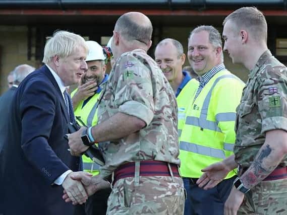 Prime Minister Boris Johnson meets with rescue crews at Whaley Bridge Football Club