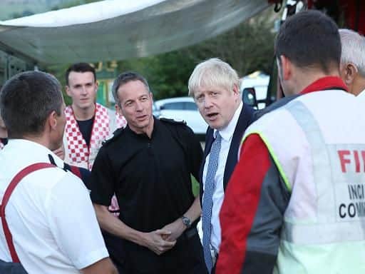 Prime Minister Boris Johnson meets with rescue crews at Whaley Bridge Football Club on Friday. Photo: Getty Images.