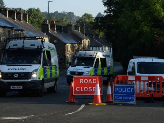 Police vehicles block the road in Whaley Bridge. Photo by Leon Neal/Getty Images.