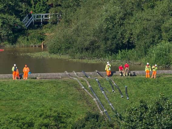 Members of the emergency services pump water from Toddbrook Reservoir. Photo: Roland Harrison/AFP/Getty Images.