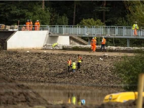 Engineers and members of the emergency services work to pump water from Toddbrook Reservoir. Photo: Oli Scarff/AFP/Getty Images.