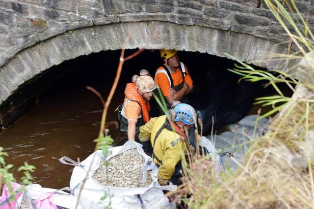 Engineers make repairs to the damaged bridge. Photo: Brian Eyre.