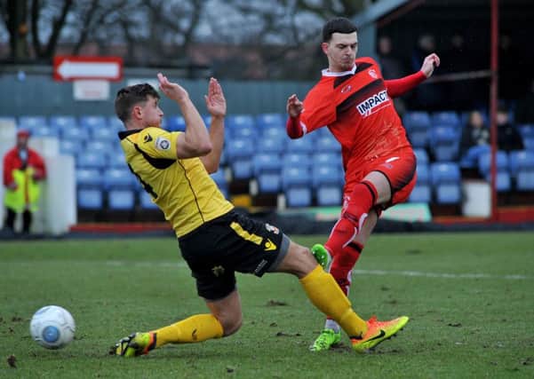 Ryan Jennings, pictured here in the red of Alfreton Town, has signed for Buxton FC