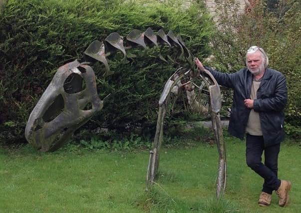 Buxton sculptor Andy Hill pictured with one of his dinosaur creations which have not been stolen
