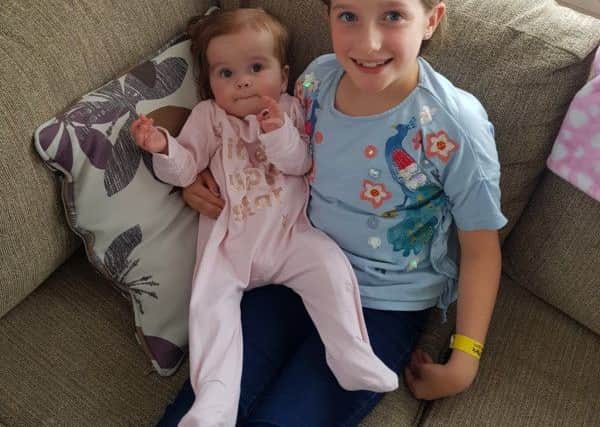 Molly at home with big sister Isla