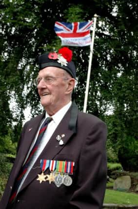 Derek Burgess proudly wears the hackle of the Black Watch beneath the Armed Services Day flag at Glossop. Derek, 89, was severely wounded at the battle of Arnham whilst trying to relieve the paratroopers in WW II.