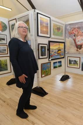 Annette Hetherington of the friends of Hadfield Hall preparing for the opening of their art exhibition