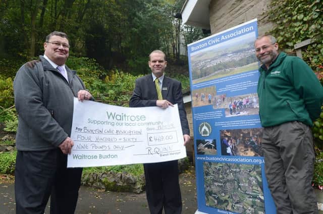 Dan Hopkinson from Waitrose hands over a donation to Paul Dinsdale and Alan Walker of Buxton Civic Association