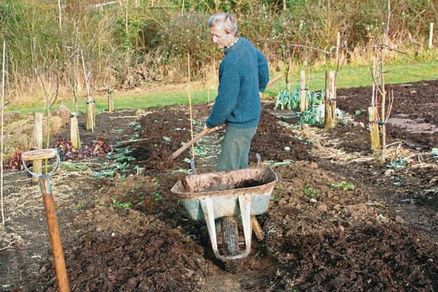 Charles Dowding composting newly-shaped beds. PA Photo/Handout.