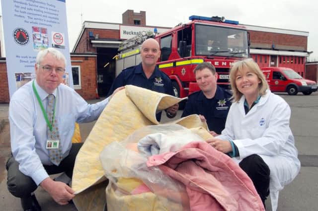 Coun Mick Murphy with Hucknall Fire Station staff, crew manager Neil Chauntry, second left, firefighter Simon Clunie and Jo MacDonald from GEMS UK Ltd who were carrying out the safety checks on electric blankets on behalf of Trading Standards.