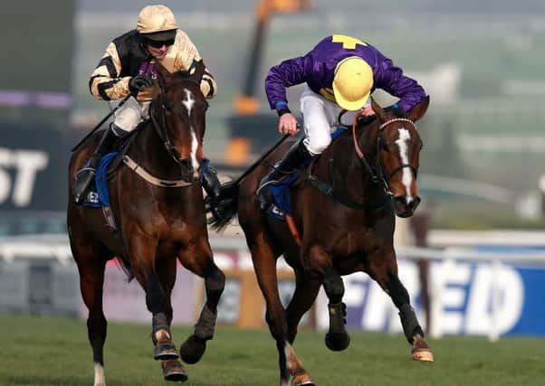 PRAISE THE LORD -- Lord Windermere (right), ridden by Davy Russell and trained by Jim Culloty, pips On His Own to victory in the Cheltenham Gold Cup (PHOTO BY: David Davies/PA Wire)