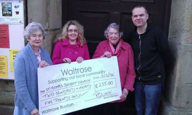 Dan Hopkinson of Waitrose presents a cheque for £235 to members of St Thomas Becket Church in Chapel-en-le-Frith.