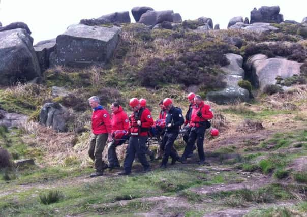 The injured climber is stretchered to an awaiting air ambulance by Buxton Mountain Rescue Team. Photo: West Midlands Ambulance Service.