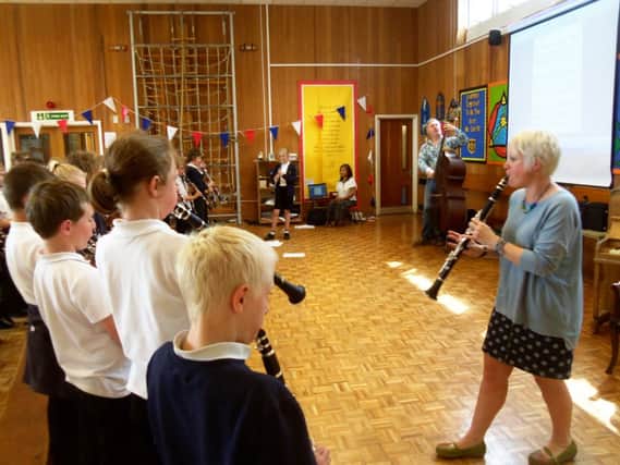 Jude Watson (Wider Opportunities Deliverer), Jamie Manson (from the Northern Chamber Orchestra) and Helen Quayle (Learning and Development Officer for the Northern Chamber Orchestra) with year six pupils.