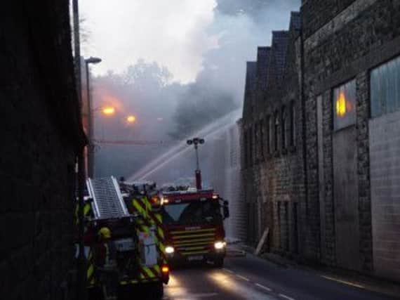Firefighters tackling the blaze at a former factory on Charlestown Road, Glossop. Photo by Chris Page.