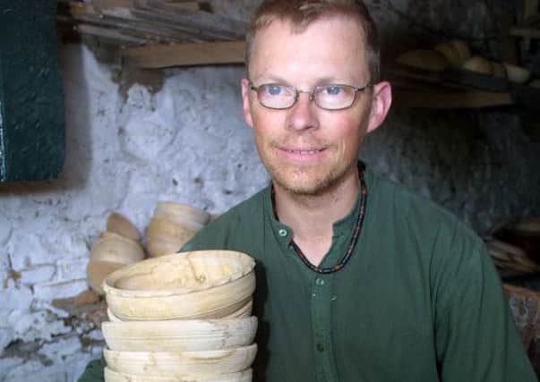 Wood turner Robin Wood with finnished bowls in his remote workshop above Edale