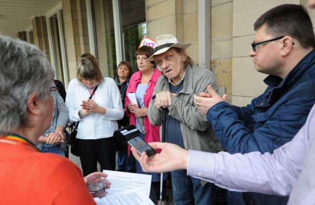 Protesters held a rally outside County Hall over the cuts.