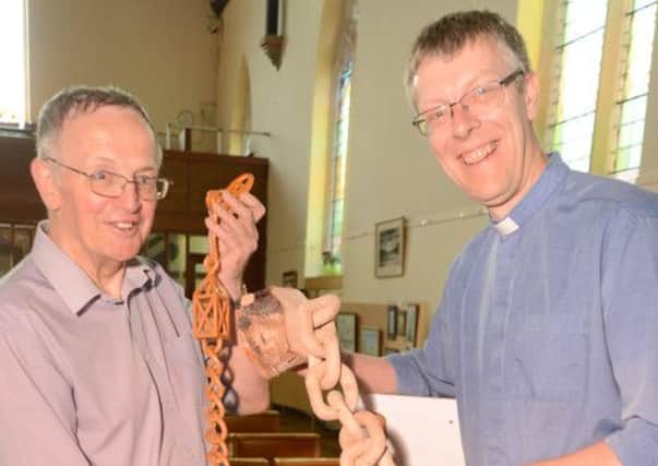 Buxton Methodists talents weekend, the Rev Andrew Parker admires the carving expertise of Philip Ray