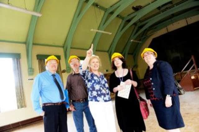 Borough and county councillors discuss plans for Glossop's Victoria Hall with library manager Julie Bedford, centre. Photo contributed.