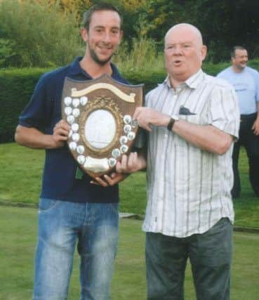 Buxton & District Bowling League Secretary Joe Pyke presents the Chell Shield to the captain of winners Chapel Park, Gary Clapham. Photo contributed.