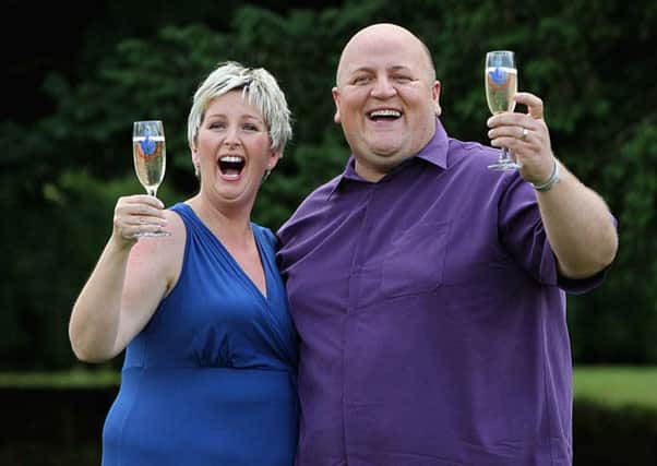 Adrian Bayford, 41, and wife Gillian, 40, from Haverhill, Suffolk, after a press conference at Down Hall Country House Hotel in Hatfield Heath, Hertfordshire, after they won £148.6 million on Friday's EuroMillions jackpot. PRESS ASSOCIATION Photo. Picture date: Tuesday August 14, 2012. The staggering sum - of £148,656,000 - is just behind the £161 million landed by Colin and Chris Weir, from Largs in North Ayrshire, last July. See PA story LOTTERY EuroMillions. Photo credit should read: Sean Dempsey/PA Wire