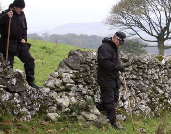 Specialist police officers search for Gary Bryan near Taddington in 2010.
