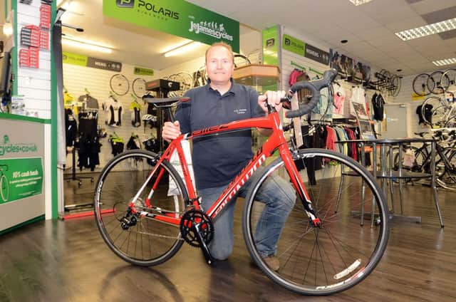 JE James cycles Chesterfield. Red Specialised bike that is being raffled for the Derbyshire Times Flag Challenge for Ashgate Hospice. Michael Burr asst manager.