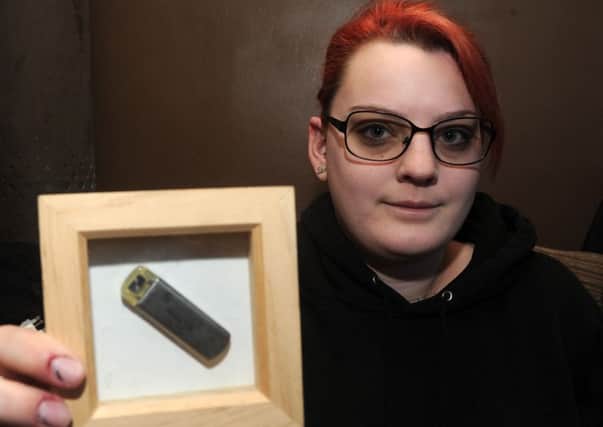 Sara Brautigam, of Kirk Sandall holds up an implantable loop recorder as she has a rare illness that causes her heart to stop beating and she is wanting to raise awareness of the condition. Picture: Andrew Roe