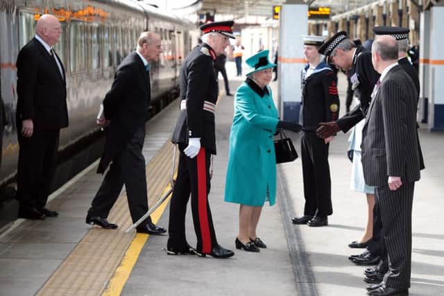 The Queen is greeted by the Lord Lieutenant David Moody and other VIPs
