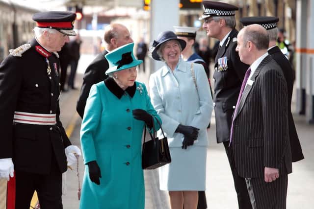 The Queen is greeted by the Lord Lieutenant David Moody and other VIPs