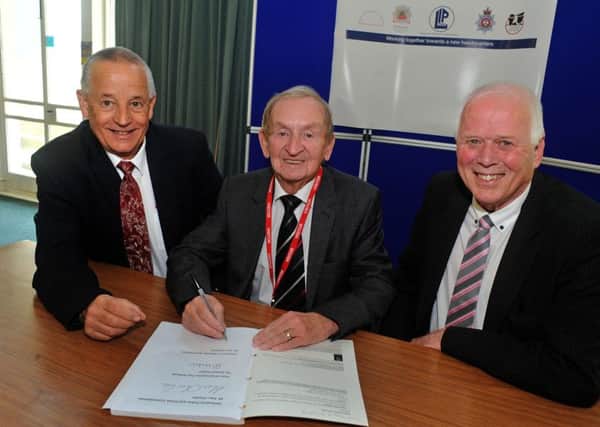The Derbyshire Police and Crime Commissioner, Alan Charles, left, Nigel Kirkland, the chairman of Bowmer and Kirkland, centre and Coun. Roland Hosker pictured at the signing of the contract for works to begin on the  joint police and fire headquarters.