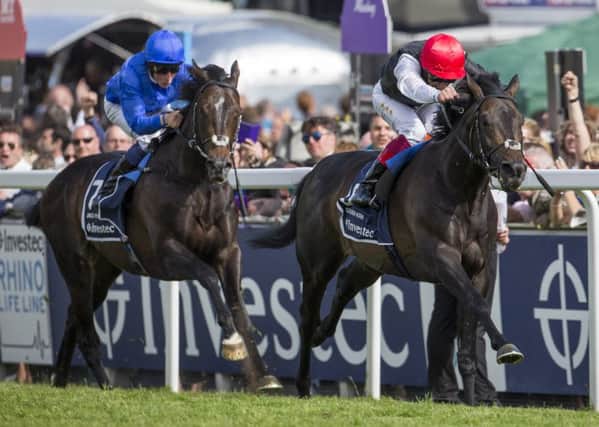 DERBY DUEL -- Golden Horn, ridden by Frankie Dettori, sweeps by stablemate Jack Hobbs to win the Investec Derby at Epsom (PHOTO BY: PA Wire).