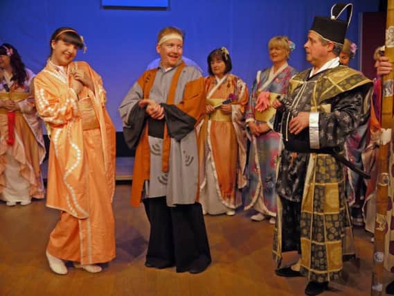 Lizzie Blades, Andrew Moore and Nic Wilson (forefront) in Matlock G & S Society's production of The Mikado.