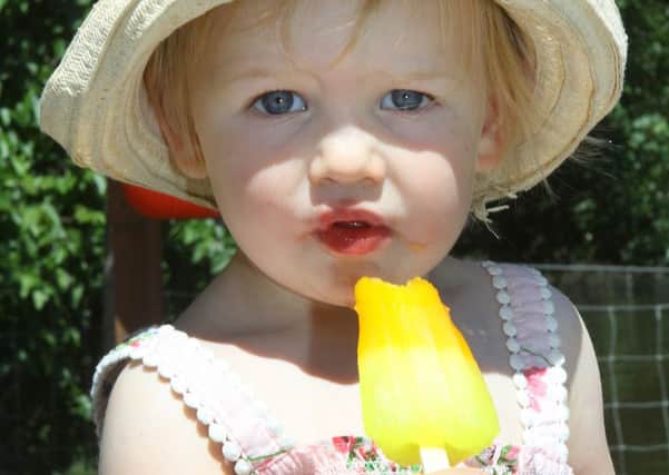 Isla Clayton, two, cools off with an ice lolly at Queen's Park, Chesterfield.
