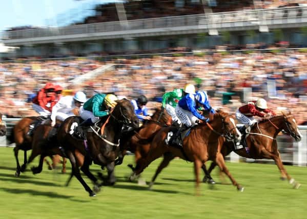 A GLORIOUS BLUR -- fast-paced action from the 2015 Qatar Goodwood Festival (PHOTO BY: John Walton/PA Wire).