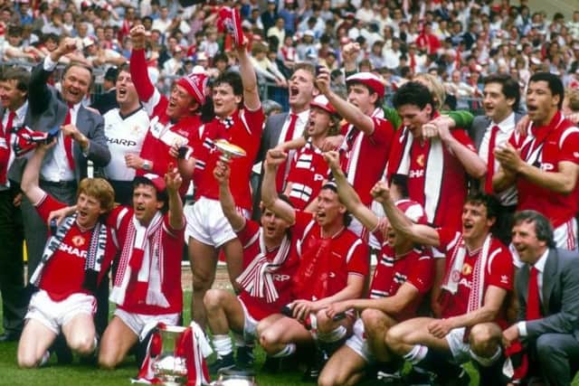 Manchester United staff and players celebrate winning the 1985 FA Cup.