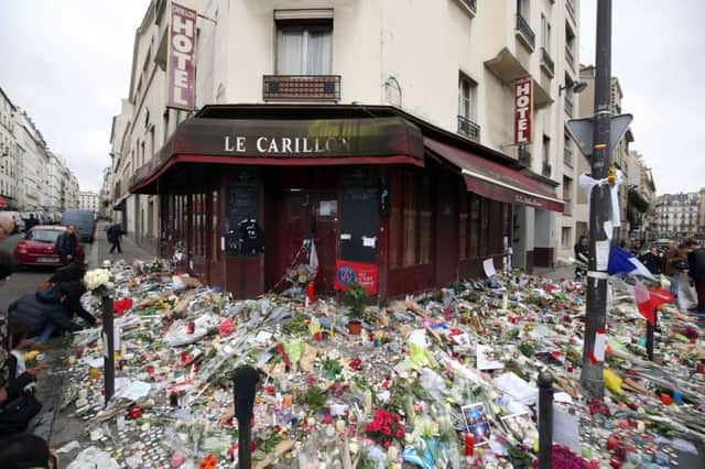 Floral tributes and candles left at Le Carillon, Paris, after terror attacks killed at least 129 people in the city last week.
