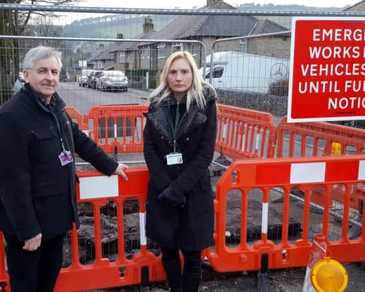 County councillor Tony Kemp with High Peak councillor Samantha Flower standing by the cordoned off hole  on Macclesfield Old Road, Buxton.