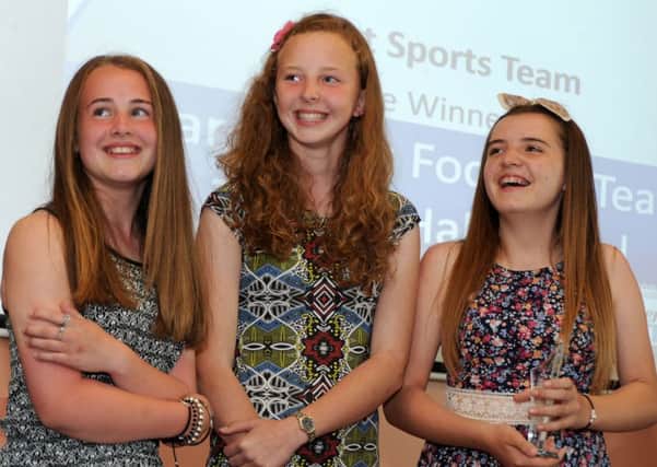 Mollie Stanley, Abbie Greaves and Olivia Buckley with the Best Sports Team award for the Tupton Hall Year 7 girls football team.