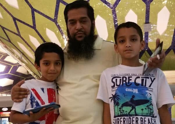 Tengi 10,000 winner Anwar Hussain with his boys Ali and Asif