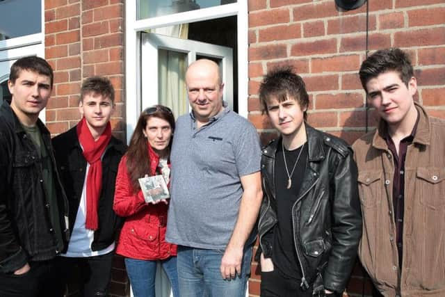 The Sherlocks Josh, Kiaran, Brandon and Andy with home owners Julie Coxhead and Richard Cannings. Photo: Glenn Ashley